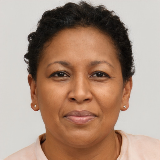 Joyful latino adult female with short  brown hair and brown eyes