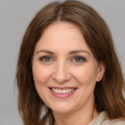 Joyful white adult female with medium  brown hair and brown eyes