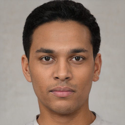 Neutral latino young-adult male with short  black hair and brown eyes