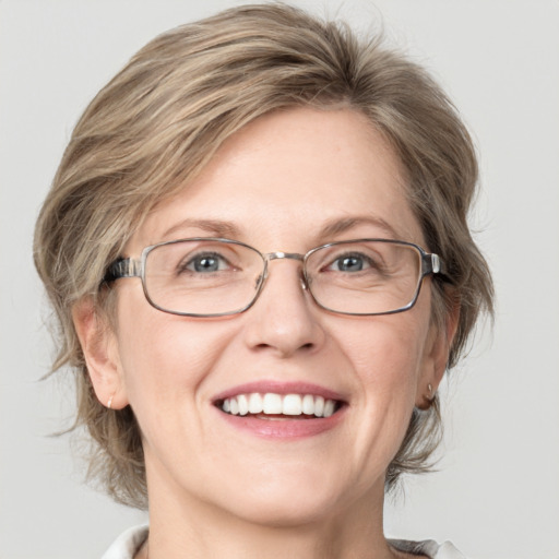 Joyful white adult female with medium  brown hair and blue eyes