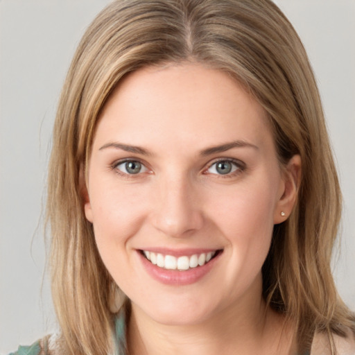 Joyful white young-adult female with long  brown hair and blue eyes