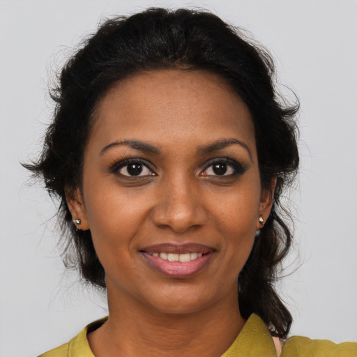 Joyful black young-adult female with medium  brown hair and brown eyes