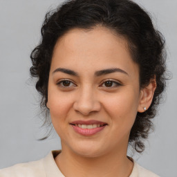 Joyful latino young-adult female with medium  brown hair and brown eyes