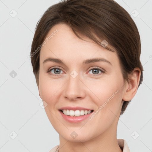 Joyful white young-adult female with short  brown hair and grey eyes