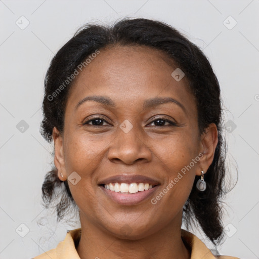 Joyful black adult female with medium  brown hair and brown eyes