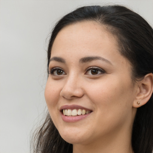 Joyful white young-adult female with long  brown hair and brown eyes