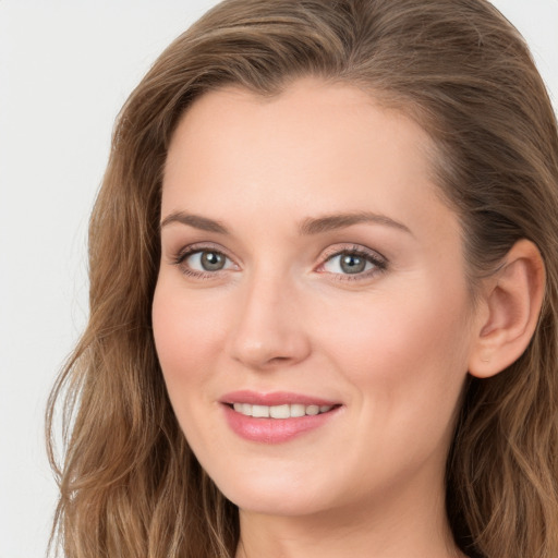 Joyful white young-adult female with long  brown hair and blue eyes