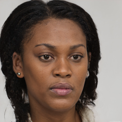 Neutral black young-adult female with long  brown hair and brown eyes
