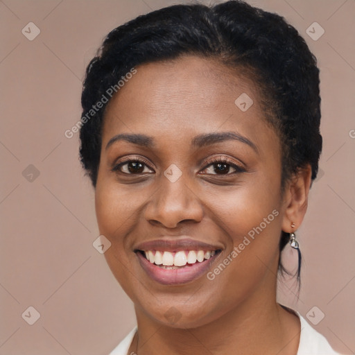 Joyful black young-adult female with short  brown hair and brown eyes