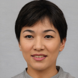 Joyful asian young-adult female with short  brown hair and brown eyes