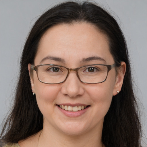 Joyful white adult female with long  brown hair and brown eyes