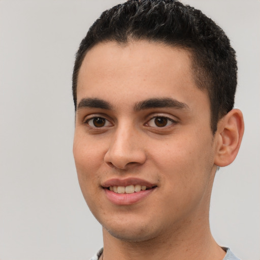 Joyful white young-adult male with short  black hair and brown eyes