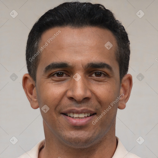Joyful latino young-adult male with short  black hair and brown eyes