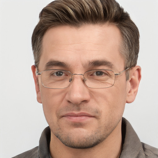 Joyful white adult male with short  brown hair and grey eyes