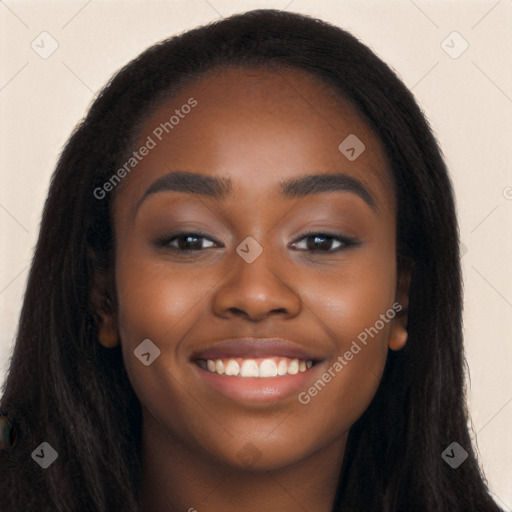 Joyful black young-adult female with long  black hair and brown eyes