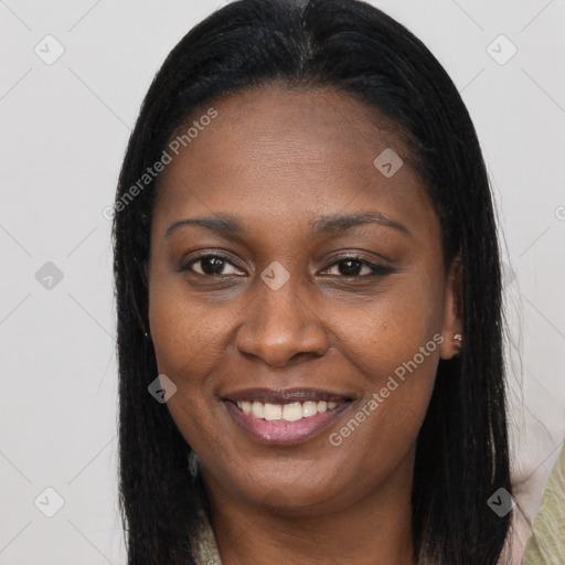 Joyful black young-adult female with long  brown hair and brown eyes