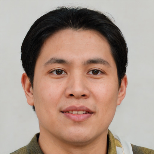 Joyful asian young-adult male with short  brown hair and brown eyes
