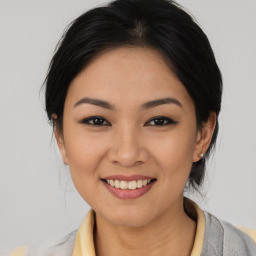 Joyful asian young-adult female with medium  black hair and brown eyes