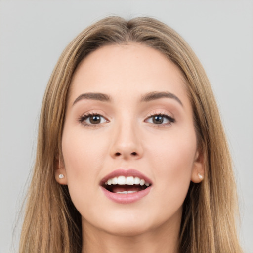 Joyful white young-adult female with long  brown hair and brown eyes