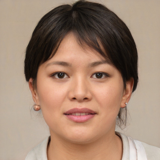 Joyful asian young-adult female with medium  brown hair and brown eyes