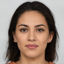 Joyful white young-adult female with long  brown hair and brown eyes