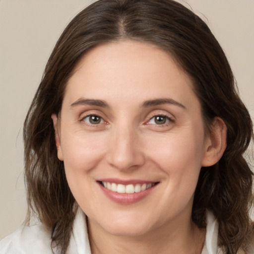 Joyful white young-adult female with medium  brown hair and brown eyes