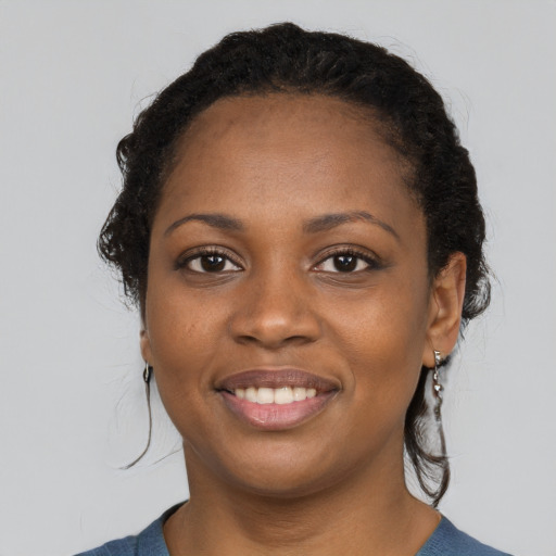Joyful black young-adult female with medium  black hair and brown eyes