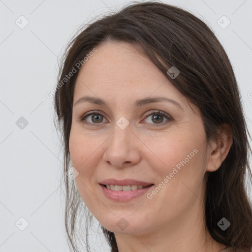 Joyful white adult female with long  brown hair and brown eyes