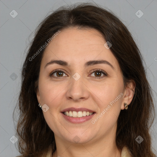 Joyful white adult female with long  brown hair and brown eyes