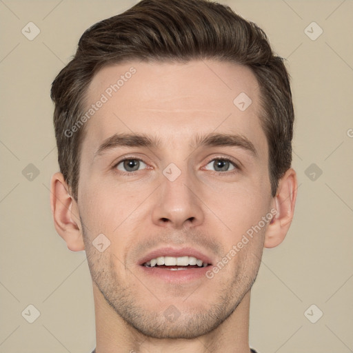 Joyful white young-adult male with short  brown hair and grey eyes