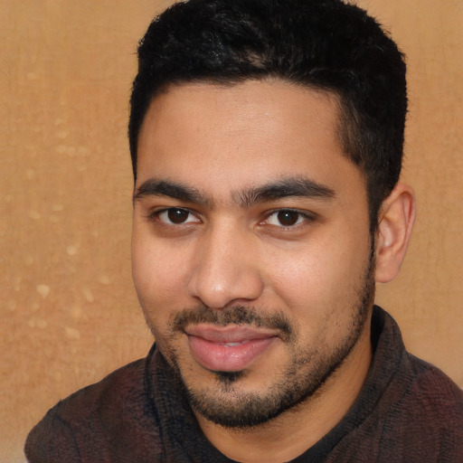 Joyful white young-adult male with short  black hair and brown eyes