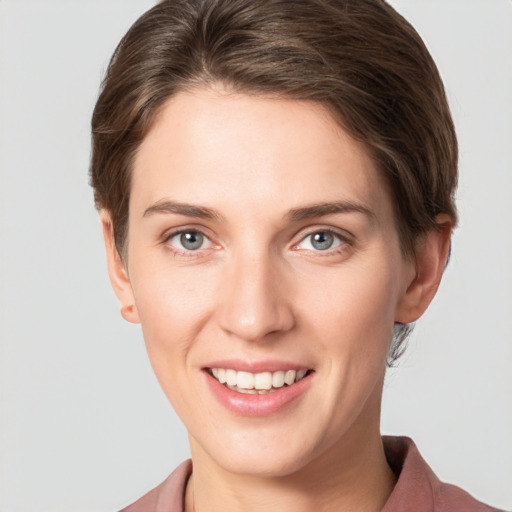 Joyful white young-adult female with short  brown hair and grey eyes