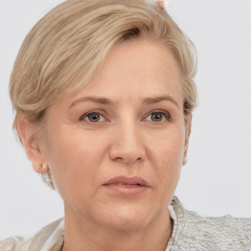 Neutral white adult female with short  blond hair and brown eyes