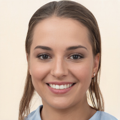 Joyful white young-adult female with long  brown hair and brown eyes