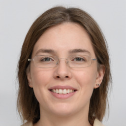 Joyful white young-adult female with medium  brown hair and grey eyes