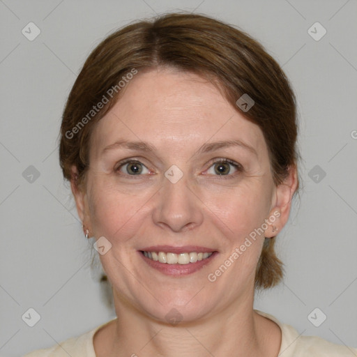 Joyful white adult female with medium  brown hair and grey eyes