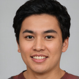 Joyful asian young-adult male with short  black hair and brown eyes