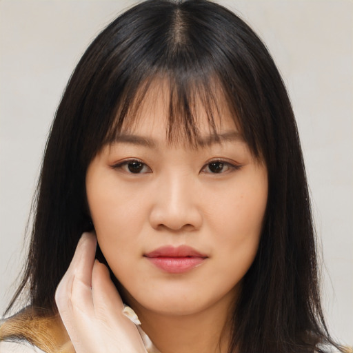 Neutral asian young-adult female with medium  brown hair and brown eyes