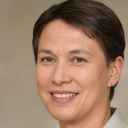 Joyful white adult female with medium  brown hair and brown eyes