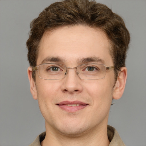 Joyful white adult male with short  brown hair and green eyes