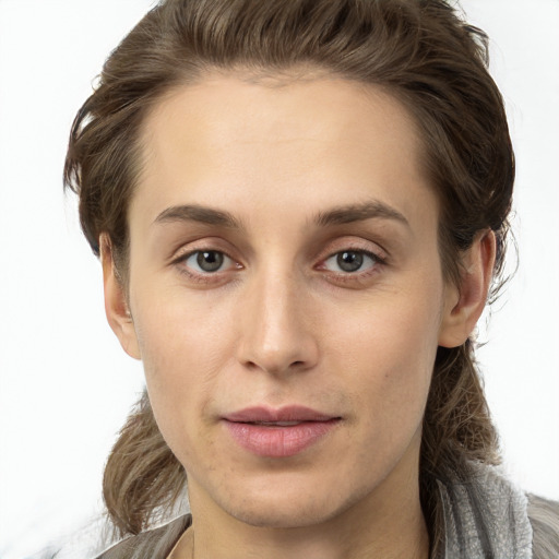 Joyful white young-adult female with long  brown hair and grey eyes