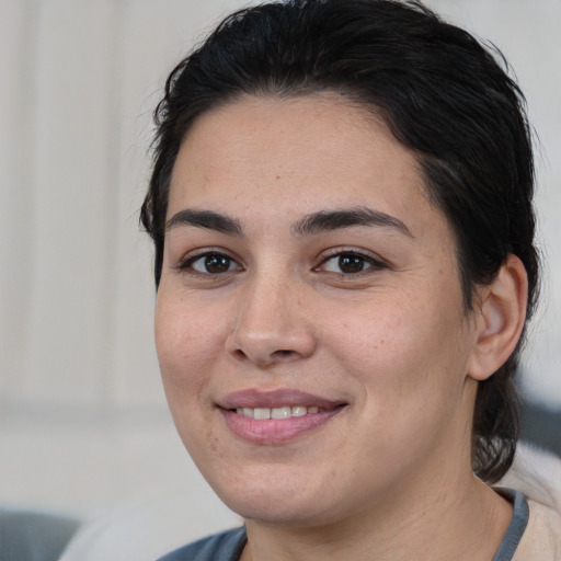 Joyful white young-adult female with medium  brown hair and brown eyes