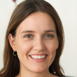 Joyful white young-adult female with long  brown hair and blue eyes