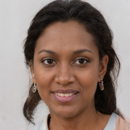 Joyful black young-adult female with medium  brown hair and brown eyes