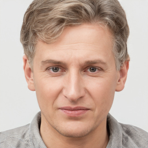 Joyful white adult male with short  brown hair and grey eyes