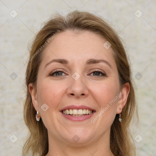 Joyful white adult female with medium  brown hair and grey eyes