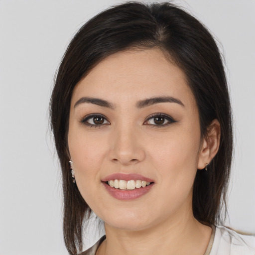 Joyful white young-adult female with long  brown hair and brown eyes