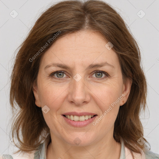 Joyful white adult female with medium  brown hair and grey eyes