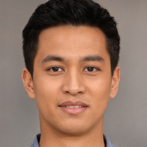 Joyful asian young-adult male with short  brown hair and brown eyes