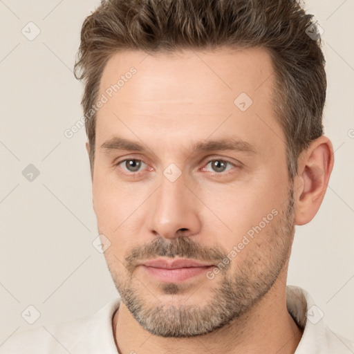 Joyful white adult male with short  brown hair and brown eyes